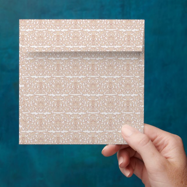 a beige and white checkered pattern on a white bac envelope (Hand)
