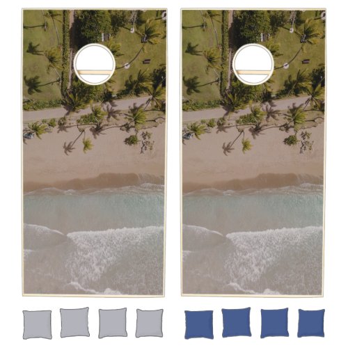 A birds eye view of a beach and ocean cornhole set