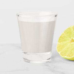 a black and white photo of a man in a suit and tie shot glass