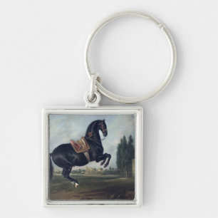 A black horse performing the Courbette Keychain