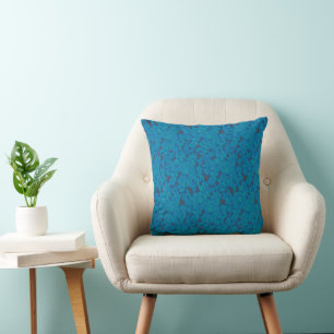 a blue and black background with a pattern throw pillow