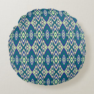 a blue and green pattern with a white background round pillow