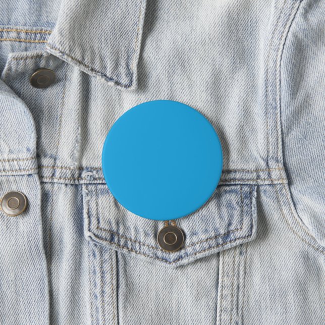 a blue background with a black and white cat button (In Situ)