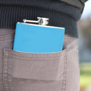 a blue background with a black and white cat flask