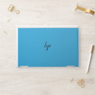 a blue background with a black and white cat HP laptop skin