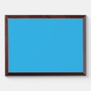 a blue background with a black and white cat on to award plaque