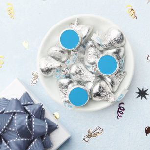 a blue background with a black and white cat on to hershey®'s kisses®