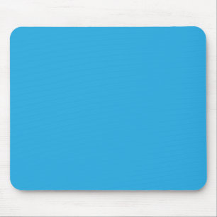 a blue background with a black and white cat on to mouse pad