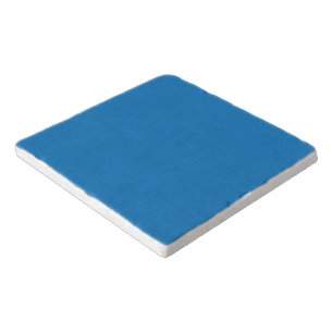 a blue background with a black and white clock trivet