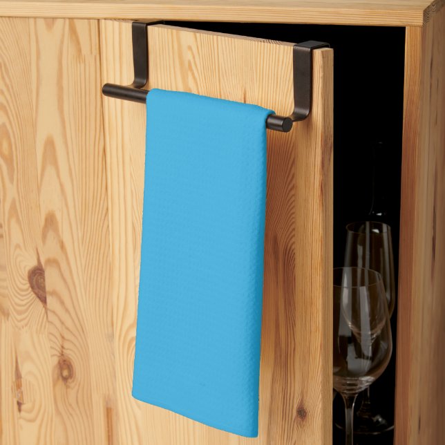 a blue background with a kitchen towel (Thirds Fold)