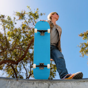 a blue sky with a plane flying in the sky skateboard