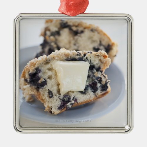 A blueberry muffin with butter metal ornament