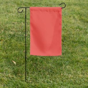 A bold red square surrounded by a crisp white bord garden flag