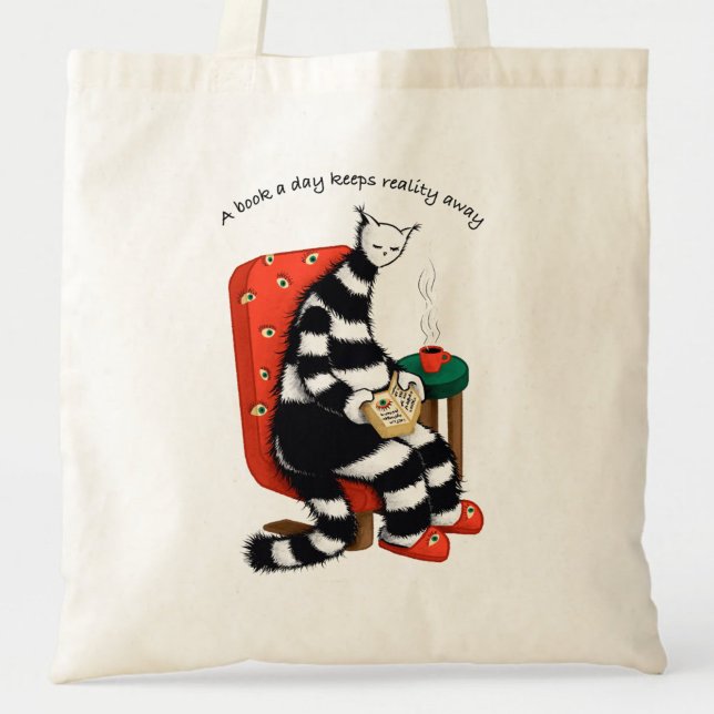 A Book A Day Keeps Reality Away - Reading Cat Tote Bag (close up of a canvas tote bag with a reading weird cat and the text a book a day keeps reality away)