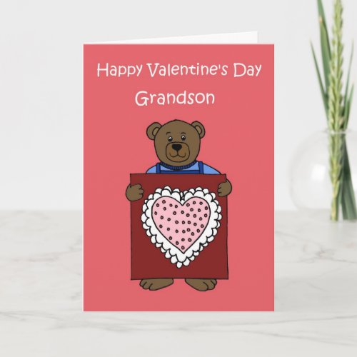 A boy bear holding a valentine holiday card