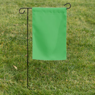 A bright green screen set against a clean white ba garden flag