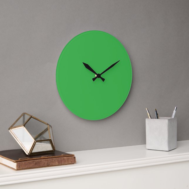 A bright green screen set against a clean white ba large clock (Office)