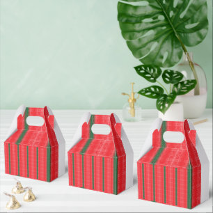 A bright red apple sits on a plain white surface. favor boxes