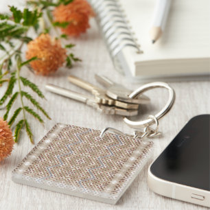 A brown rug displaying a symmetrical design featur keychain