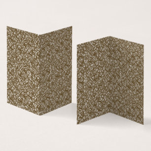 A brown rug with a geometric motif is partially co