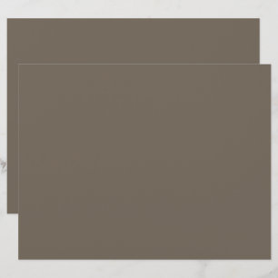 a brown wall with a black and white clock on it letterhead