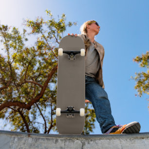 a brown wall with a black and white clock on it skateboard