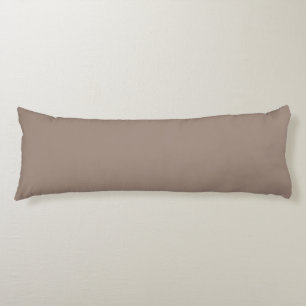 a brown wall with a clock on it body pillow