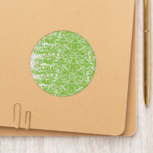 A brown wooden table holds a glass bottle of olive patch