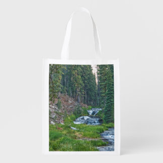 A Buck Rests at a Cascading River Grocery Bag