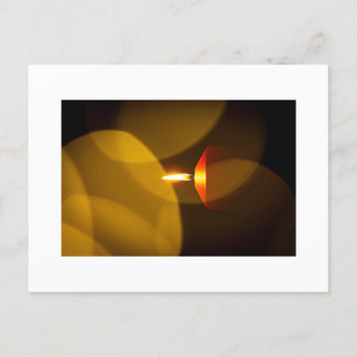 A burning candle postcard