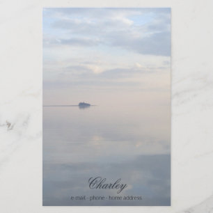 A calm sea, reflections and the island stationery