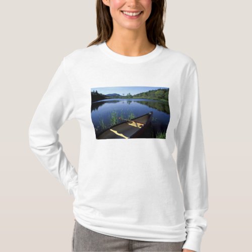 A canoe rests on the shore of Little Long Pond T_Shirt