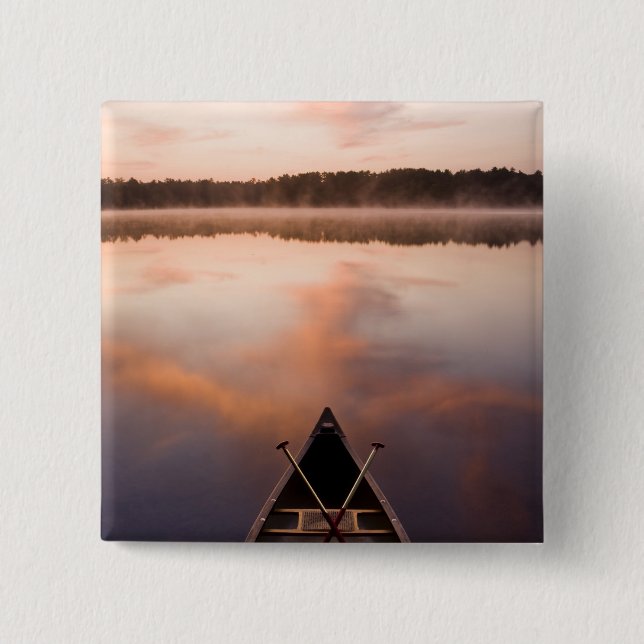 A canoe rests on the shore of Pawtuckaway Lake Button (Front)
