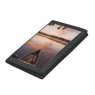 A canoe rests on the shore of Pawtuckaway Lake Tri-fold Wallet