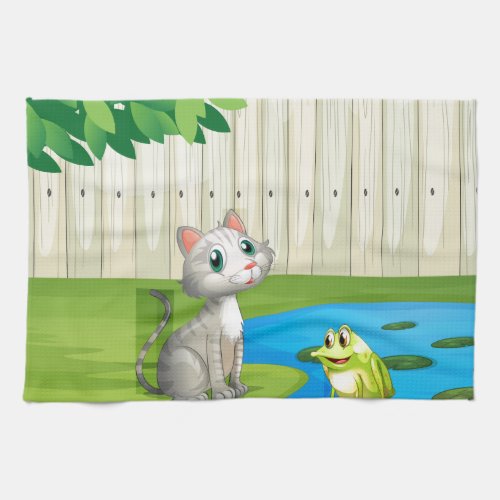 A cat and a frog inside the fence towel