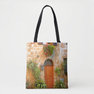 A cat seeks entrance to home in Pienza, Italy Tote Bag