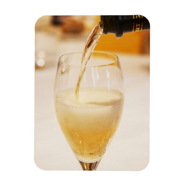 A champagne glass flute being filled with Gosset Magnet (Vertical)