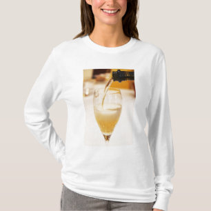 A champagne glass flute being filled with Gosset T-Shirt