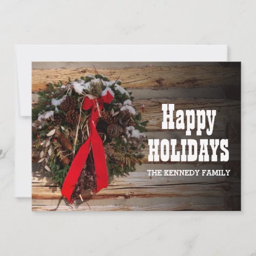 A Christmas wreath on a cabin wall Holiday Card