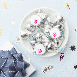 A circular logo featuring a heart symbol, embodyin hershey®'s kisses®
