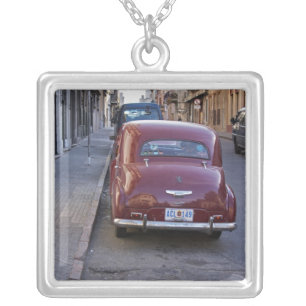 A classic old red Peugeot car parked on a street Silver Plated Necklace