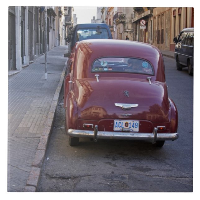 A classic old red Peugeot car parked on a street Tile (Front)