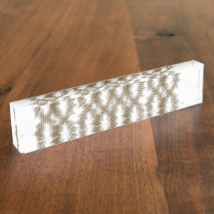 A close-up view of a crisscrossing wire mesh grid desk name plate