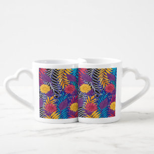 a colorful flower and leaves pattern on a blue bac coffee mug set