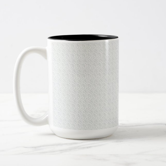 A completely white, featureless surface fills the  Two-Tone coffee mug (Left)