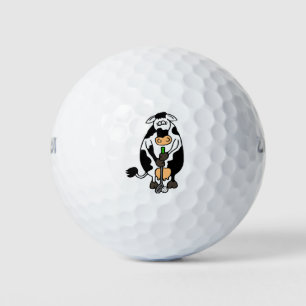 A cow playing golf balls