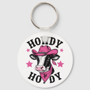 A cow wearing a vibrant pink cowboy keychain