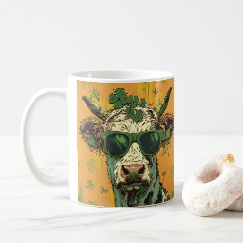 A cow with sunglasses and shamrocks on her head coffee mug