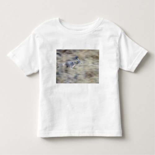 A coyote runs through the hillside blending into toddler t_shirt
