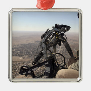 A crew chief looks for suspicious activity metal ornament